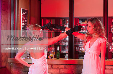 two girls at bar with plastic guns