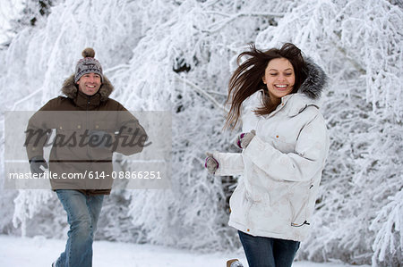 Couple running in the snow.