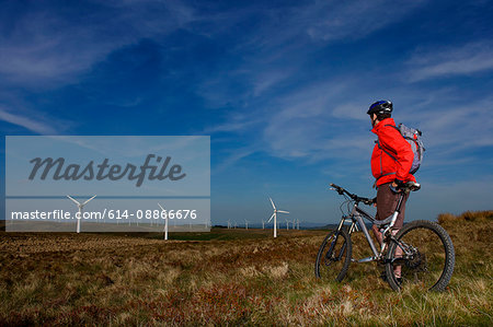 Mountain biker at a wind farm.