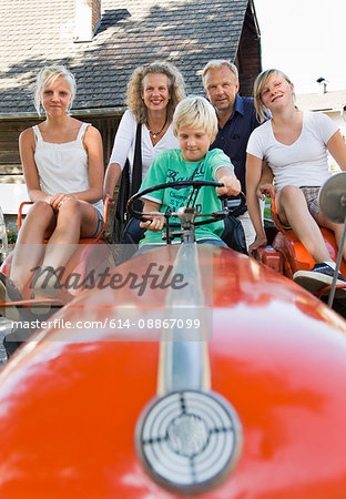 family sitting on tractor