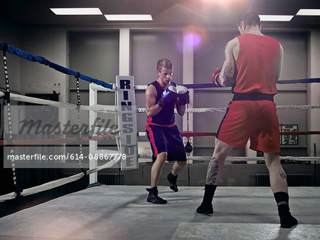 Boxers fighting in ring