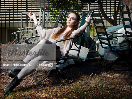 Woman smoking in lawn chair