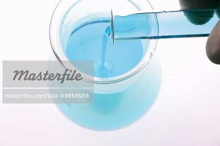 Close up of liquid pouring into beaker Close up of liquid pouring into beaker