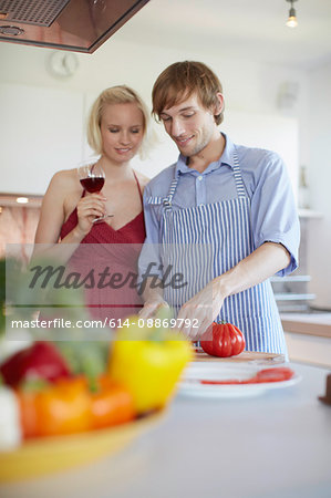 Couple cooking together in kitchen