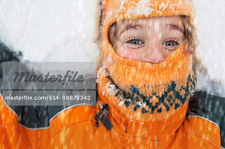 Close up of boy playing in snow