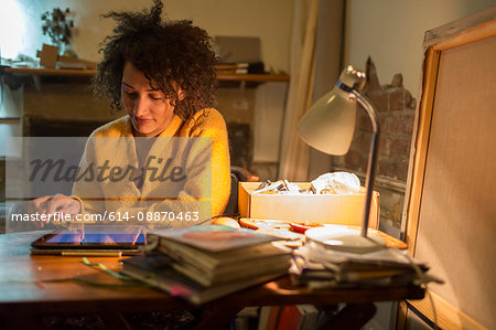 Woman using tablet computer at desk