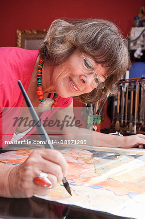 Older woman painting with watercolors