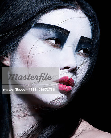 Young woman with dramatic makeup, black eyeshadow