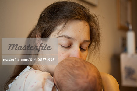 Mother kissing newborn baby boy