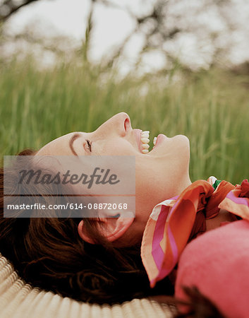 Woman lying in grass smiling