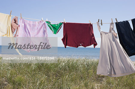 Laundry drying on clothes line by sea