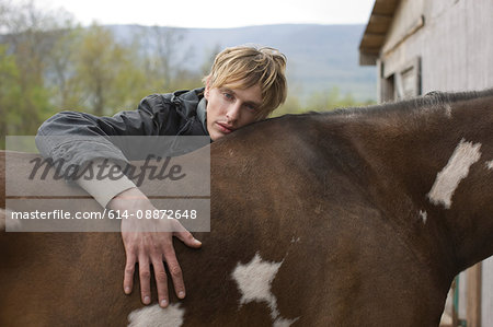 Man leaning on horse