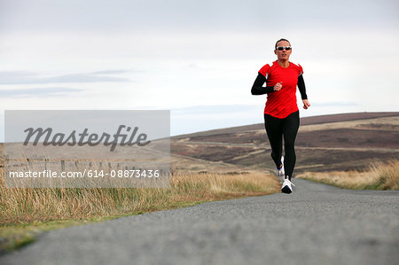 Triathlete running on rural road