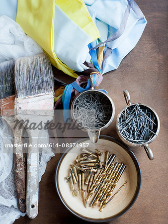 Still life of decorating brushes, textiles and nails