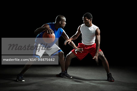 Basketball players competing for ball