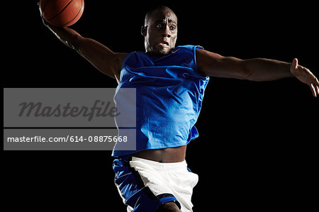 Male basketball player shooting ball