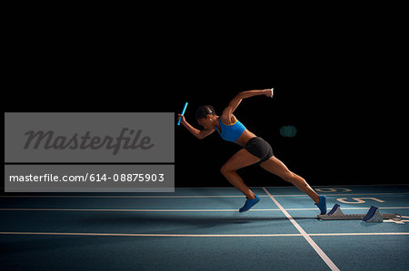 Young female athlete in relay race