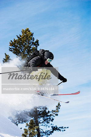 Male skier mid air