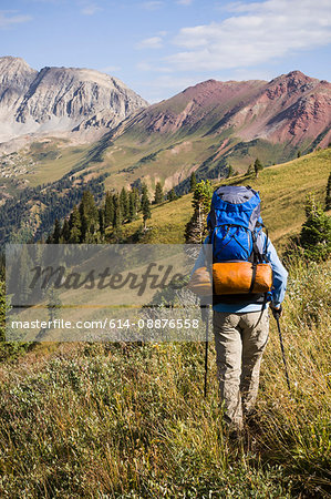 Woman backpacking in Hasley Basin, West Elk Mountains, Colorado, USA