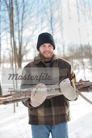 Man gathering wood in forest, Young's Point, Ontario, Canada