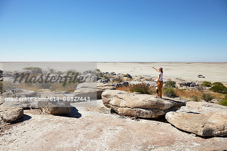 Mother and son on rock, Kubu Island, Makgadikgadi Pan, Botswana, Africa