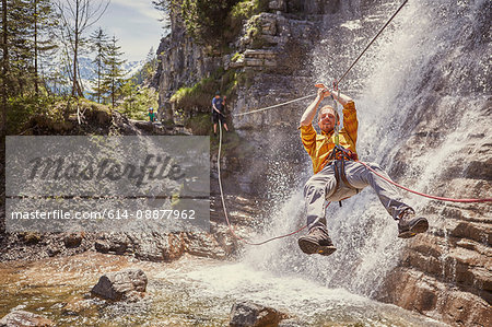 Man rappelling waterfall, Ehrwald, Tyrol, Austria