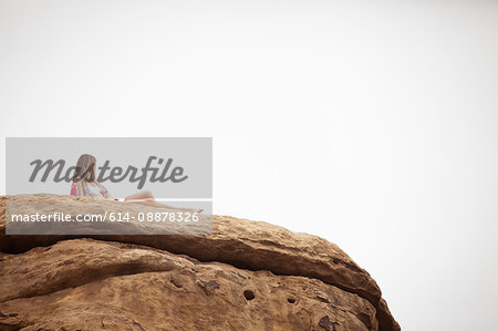 Woman relaxing on rock formation, Stoney Point, Topanga Canyon, Chatsworth, Los Angeles, California, USA