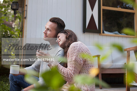 Couple drinking coffee on chalet porch