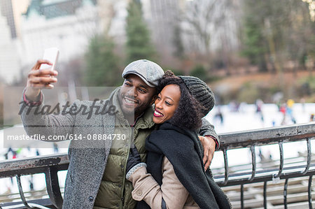 Couple taking smartphone selfie on city balcony Couple taking smartphone selfie on city balcony