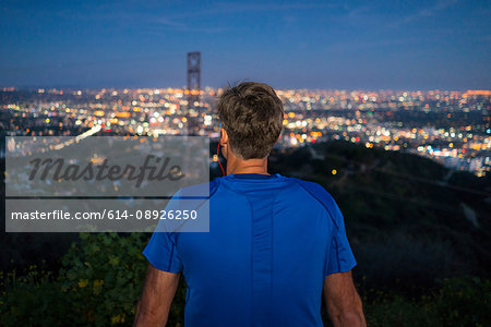 Rear view of jogger looking away at view, Runyon Canyon, Los Angeles, California, USA