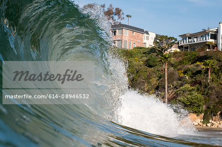 Close up surface level view of rolling wave and beach, Laguna Beach, California, USA