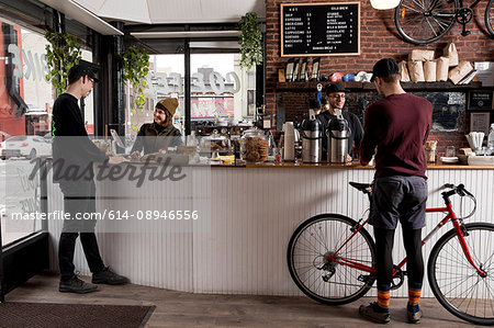 Employees serving customers in cafe, Nike and Coffee shop, New York, USA