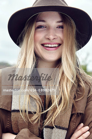 Portrait of blond haired young woman in outdoor clothes