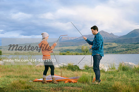 Couple in rural setting, putting up tent, Heeney, Colorado, United States