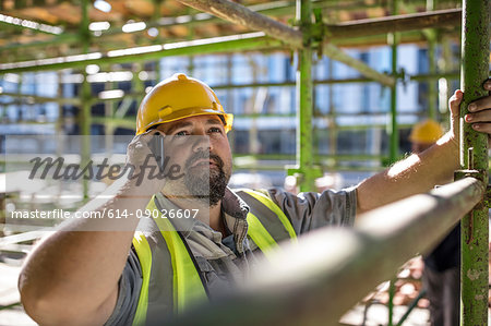 Construction worker using mobile phone