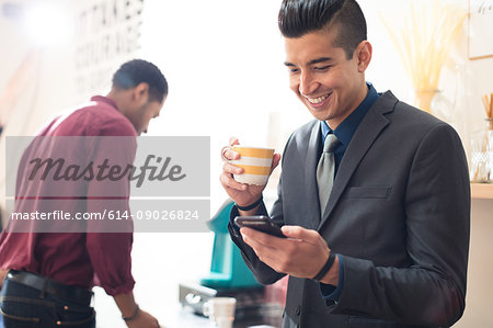 Young businessman looking at smartphone