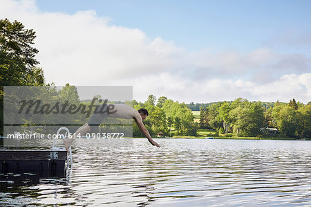 Mature man diving into lake