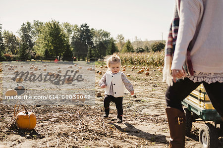 Mother and daughter in field of pumpkins, Oshawa, Canada, North America