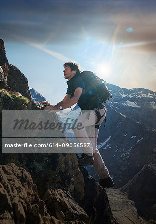 Mature male climber climbing up Jegihorn, Valais, Switzerland