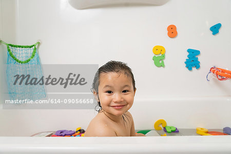 Little boy in bath tub at bath time