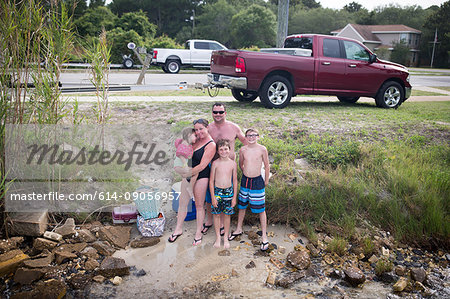 Family on sand bank by water, Destin, Florida