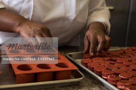 Cropped view of chef preparing cakes