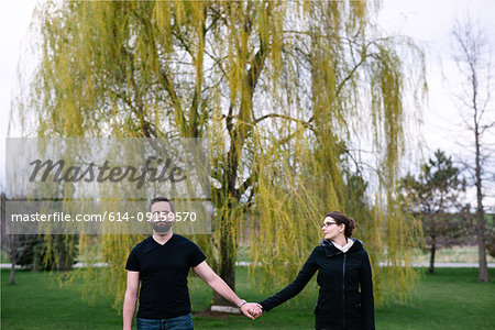 Couple in front of willow tree in park, Kingston, Canada