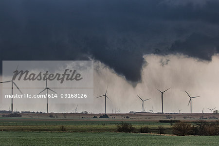 Tornado (with no visible contact over ground) behind wind farm over rural Kansas, US