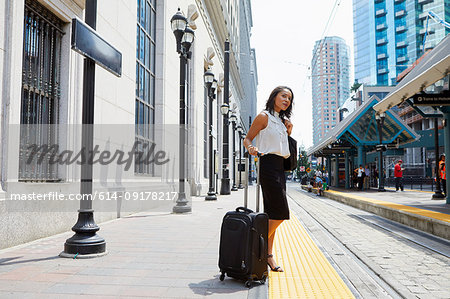 Businesswoman waiting on light rail platform