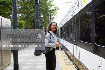 Businesswoman on platform by train