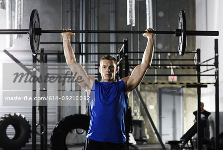 Man lifting barbell above his head