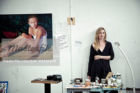 Mid adult woman standing in artist's studio, portrait