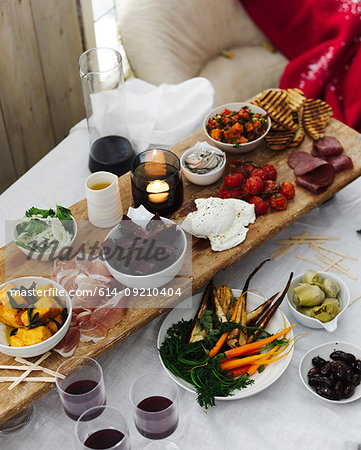 Dining table selection of antipasto with red wine Dining table selection of antipasto with red wine