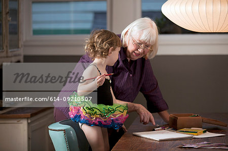 https://image1.masterfile.com/getImage/614-09210507em-grandmother-and-granddaughter-standing-at-table-drawing-stock-photo.jpg